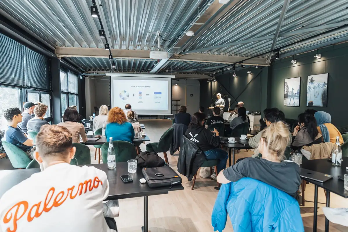 Teilnehmende eines Seminars vor einer Präsentation im Schulungsraum